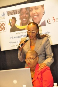 Susan L. Taylor of Cares Mentoring (standing) urges women to demand respect during the Black Women's Roundtable/CBCF "Power of the Sister Vote Forum" in DC as Melanie L. Campbell, BWR convener, pulls up voting statistics.